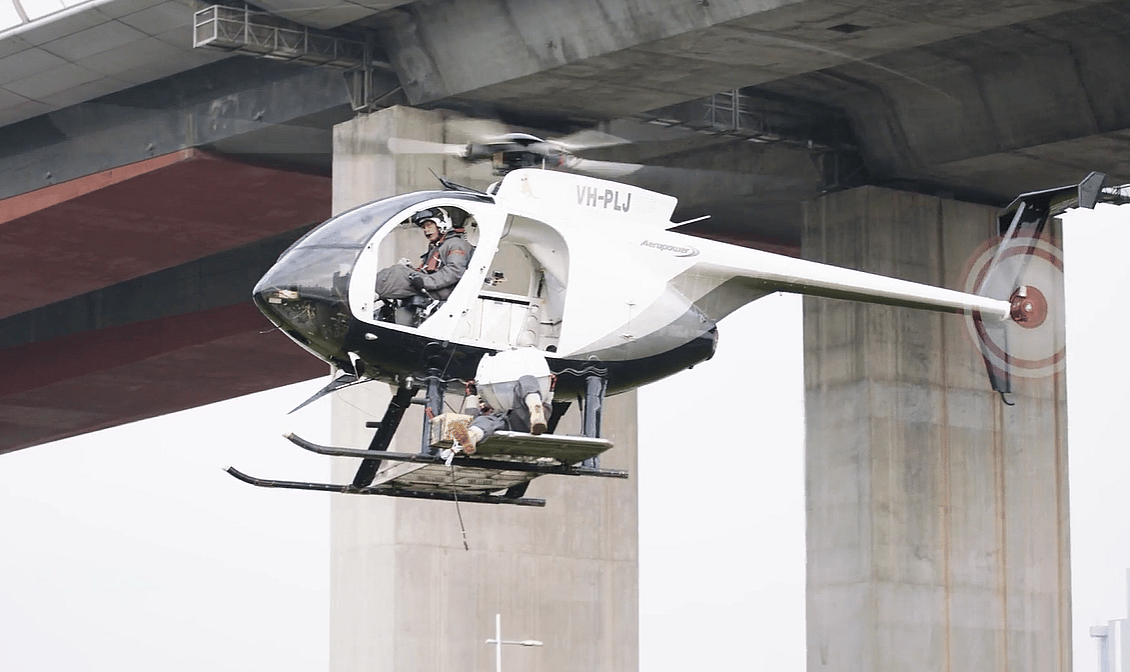 Helicopter removing a marker ball from power lines near Melbourne's Bolte Bridge